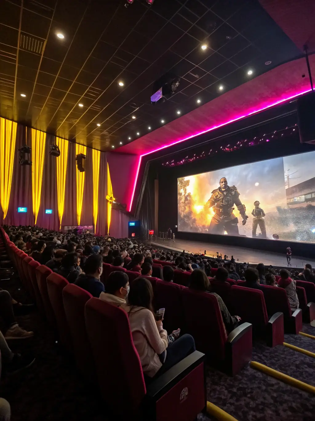 A vibrant image of a film screening event, showcasing a diverse audience enjoying an art-house film at Les Cinglés du Cinéma.